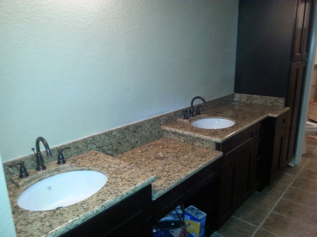 Custom fabrication and installation of cabinetry, natural stone countertops