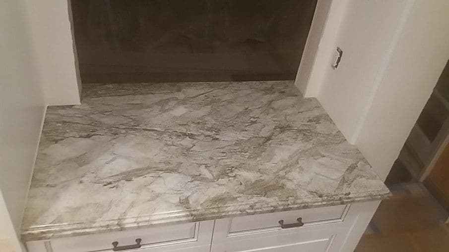 Granite countertop with intricate patterns and natural tones in a kitchen setting.